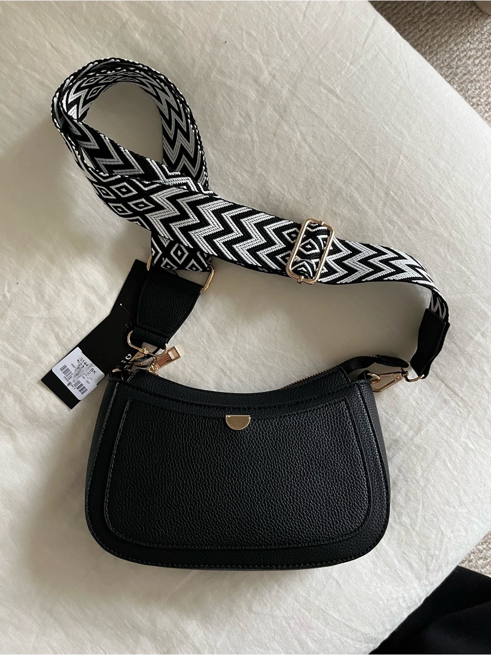 Black Crossbody Saddle Bag with Patterned Strap